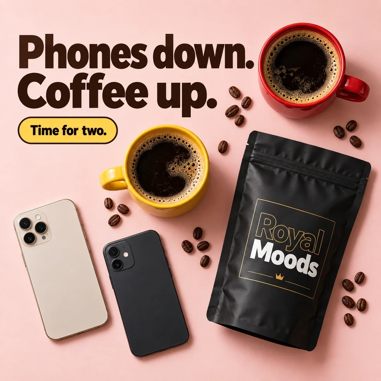 Two phones face down beside two mugs of coffee and a Royal Moods pouch